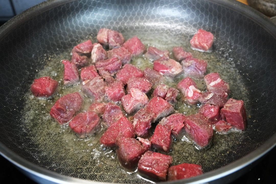 sauteing sirloin steak in a hybrid stainless steel nonstick frying pan