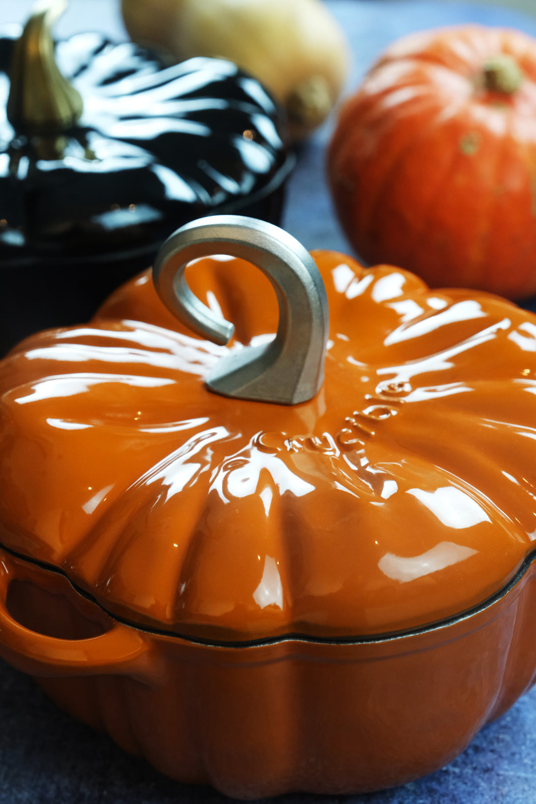 Enameled Cast Iron Pumpkin Pot in orange on the table vertical